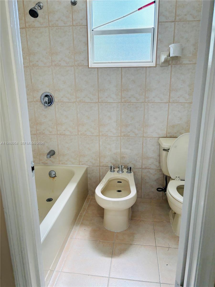 4621 Southwest 99th Court Miami, FL 33165 - Photo 10 of 10 a bathroom with a sink a toilet and bathtub