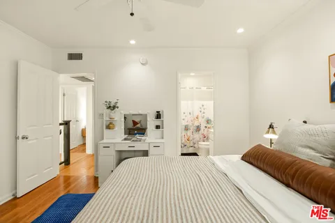 a bedroom with a bed and a dresser