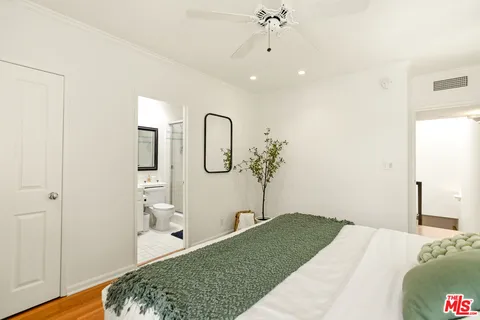 a bathroom with a toilet sink vanity and mirror