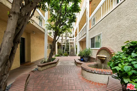 a view of a patio with table and chairs and potted plants
