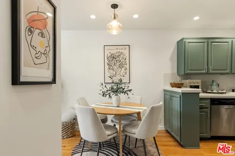a dining room with furniture and a wooden floor