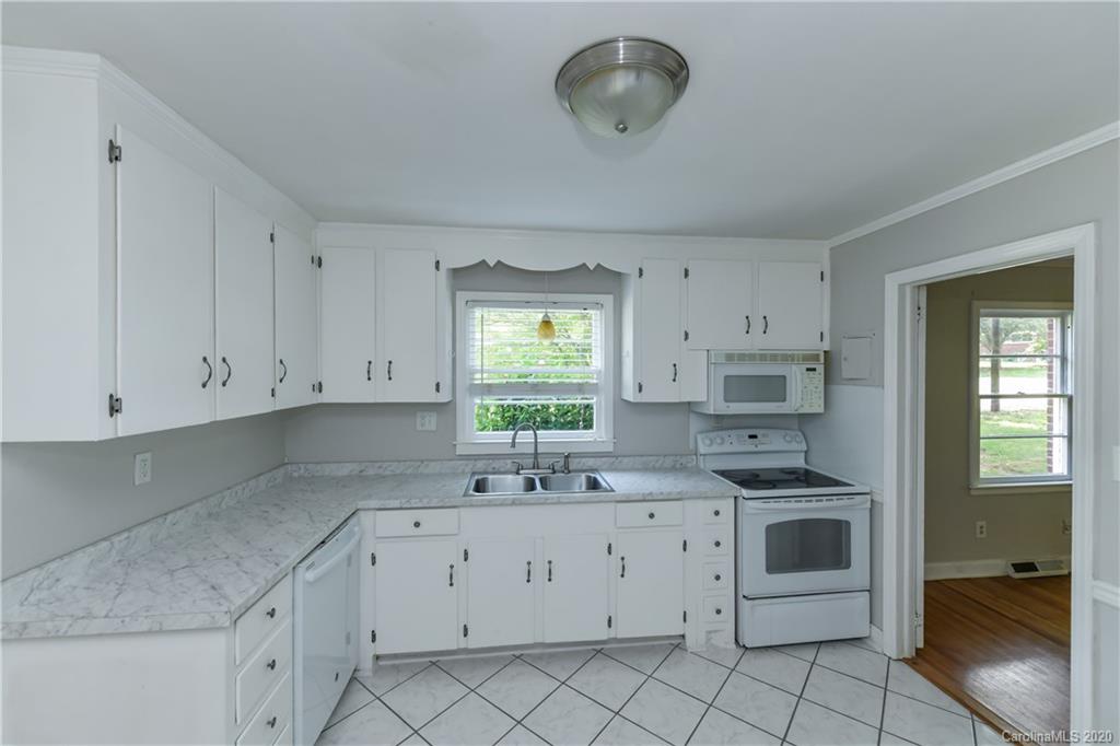 2255 Falmouth Road Charlotte, NC 28205 - Photo 14 of 28 a kitchen with cabinets appliances a sink and a window
