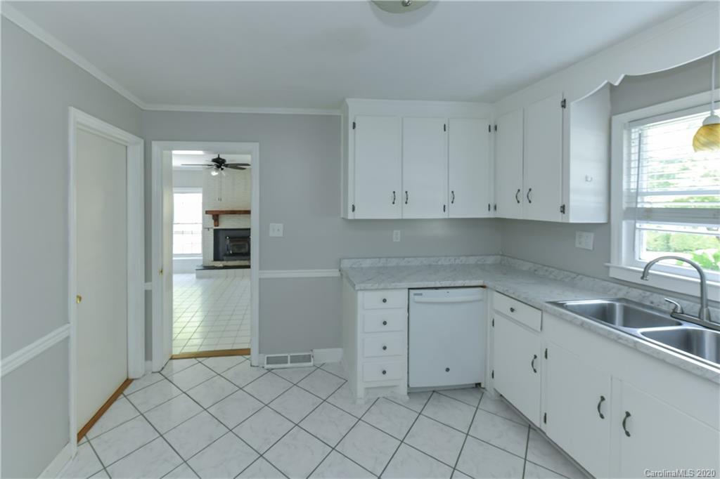 2255 Falmouth Road Charlotte, NC 28205 - Photo 15 of 28 a kitchen with white cabinets appliances and a sink