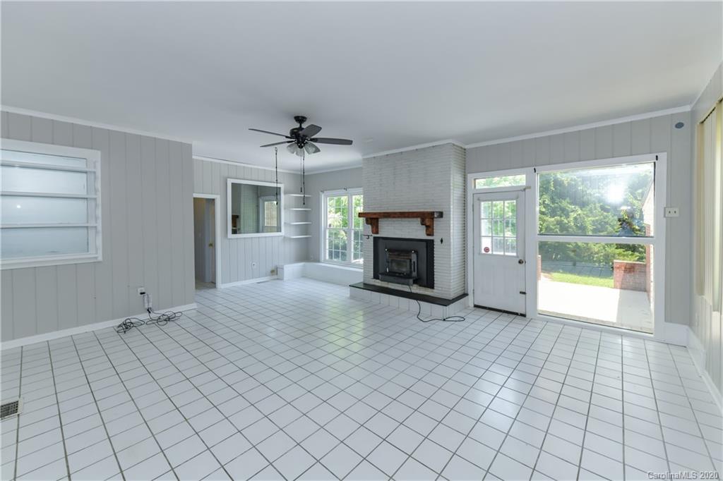 2255 Falmouth Road Charlotte, NC 28205 - Photo 16 of 28 a view of empty room with fireplace and fan
