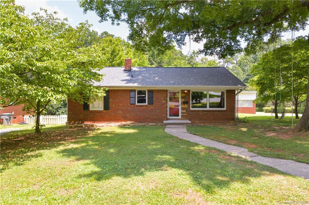2255 Falmouth Road Charlotte, NC 28205 - Photo 3 of 28 a front view of a house with a garden and trees