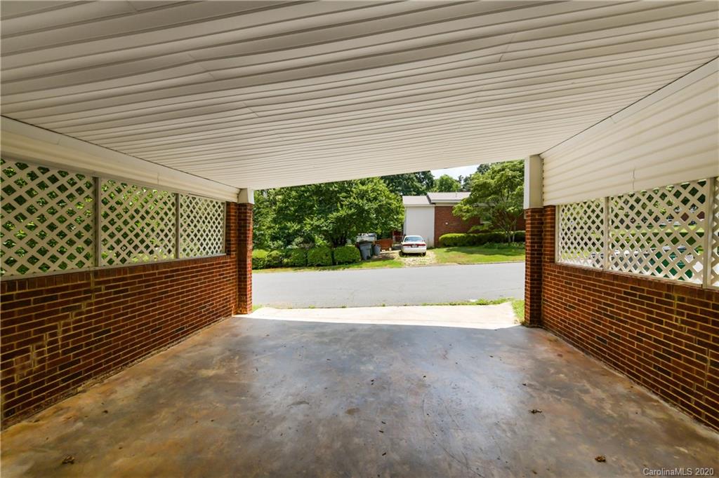 2255 Falmouth Road Charlotte, NC 28205 - Photo 28 of 28 a view of a room with wooden floor next to a iron stairs