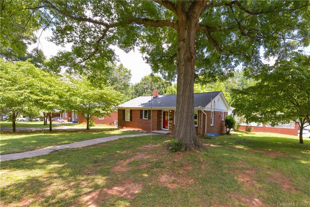 2255 Falmouth Road Charlotte, NC 28205 - Photo 4 of 28 a view of a house with a big yard and large trees