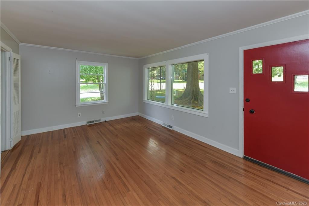 2255 Falmouth Road Charlotte, NC 28205 - Photo 8 of 28 a view of an empty room with wooden floor and a window