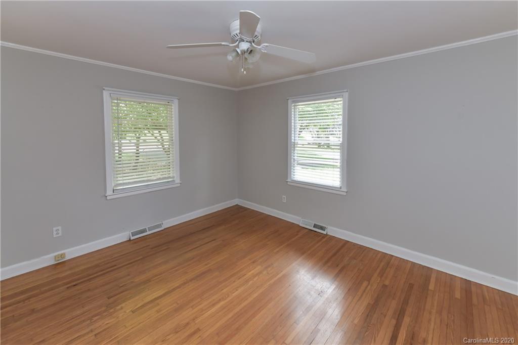 2255 Falmouth Road Charlotte, NC 28205 - Photo 9 of 28 a view of an empty room with wooden floor and a window