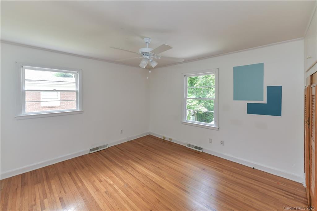 2255 Falmouth Road Charlotte, NC 28205 - Photo 10 of 28 a view of an empty room with wooden floor and a window