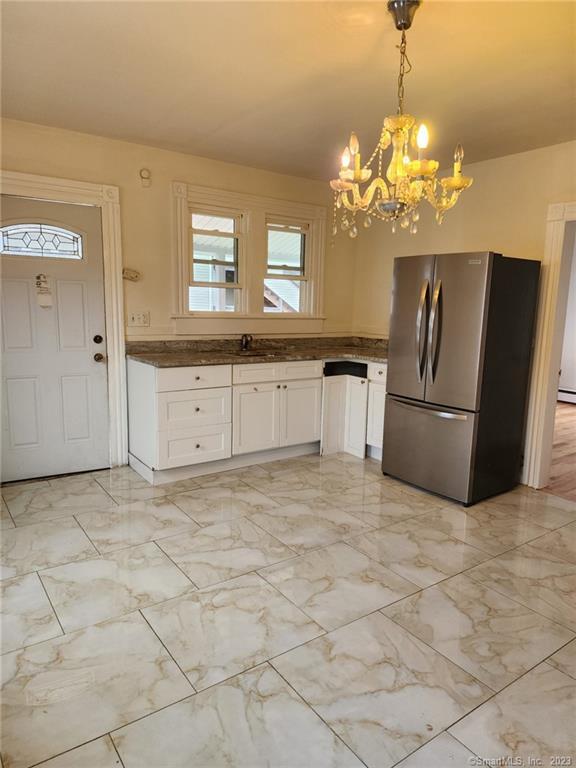 53 Cliff Street Shelton, CT 06484 - Photo 2 of 13 a view of a kitchen with a stove cabinets and a chandelier
