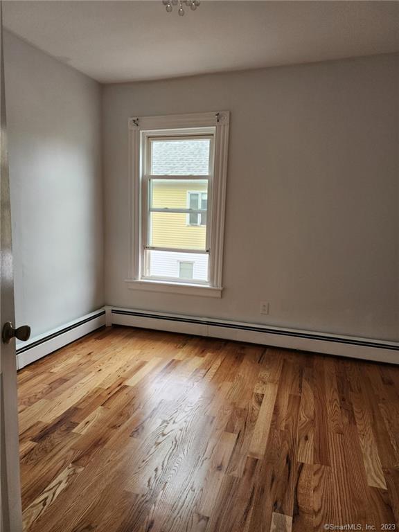 53 Cliff Street Shelton, CT 06484 - Photo 6 of 13 a view of an empty room with wooden floor and a window