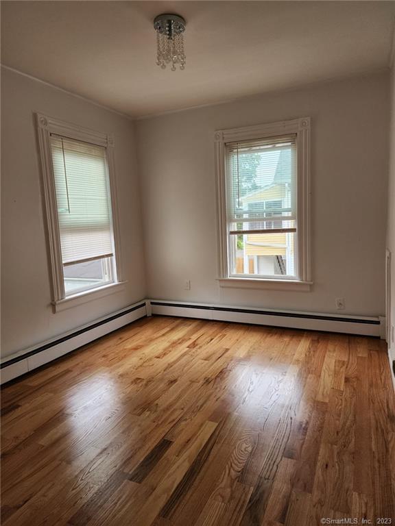 53 Cliff Street Shelton, CT 06484 - Photo 7 of 13 an empty room with wooden floor and windows