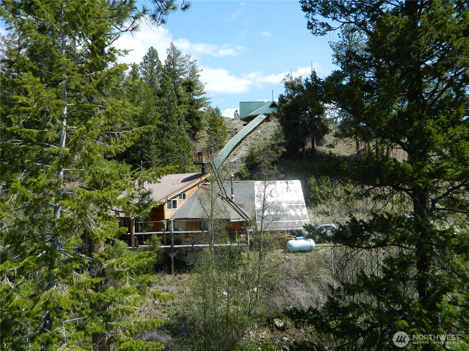 0 High Country Drive West Tonasket, WA 98855 - Photo 9 of 37 a house is sitting in middle of the forest