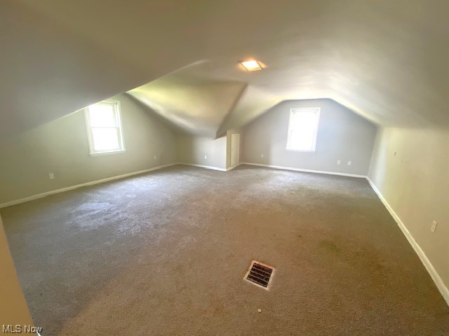 4230 Bluestone Road South Euclid, OH 44121 - Photo 18 of 35 Upstairs bedroom featuring lofted ceiling, dark carpet, and plenty of natural light