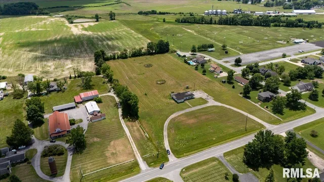 an aerial view of a house with a garden and lake view