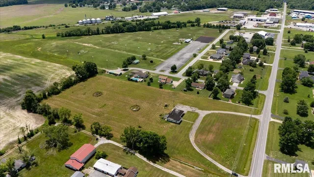 an aerial view of a pool with a yard