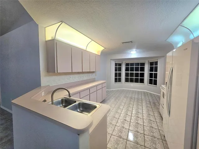 a view of a sink and dishwasher with wooden floor