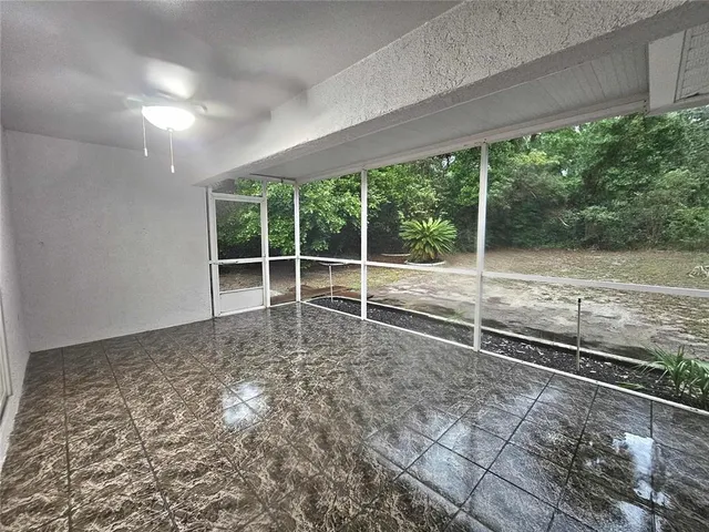 a view of a yard with wooden fence