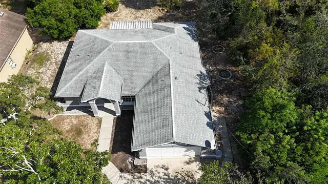 an aerial view of a house with outdoor space and sitting area