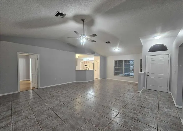 a view of an empty room and a window