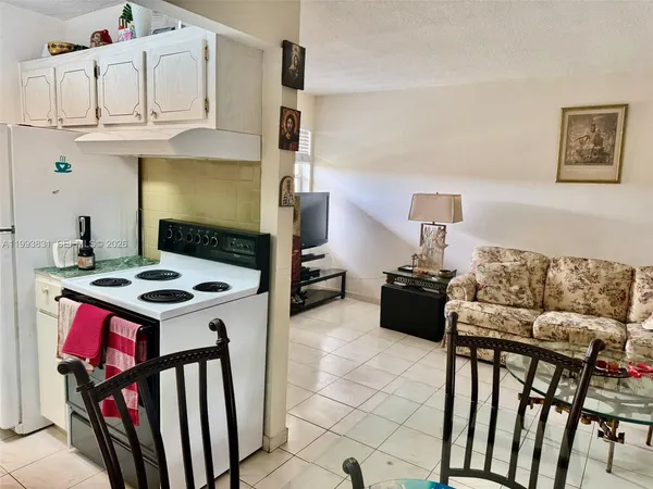 a kitchen with stainless steel appliances kitchen island granite countertop a stove a sink and a refrigerator