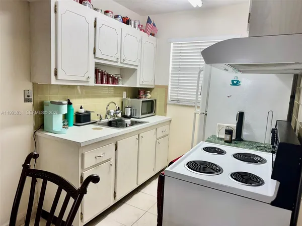 a kitchen with cabinets and appliances
