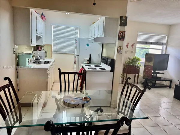 a dining room with furniture and window