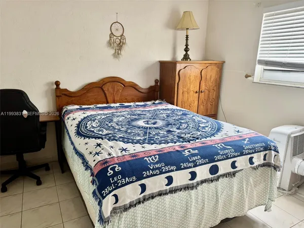 a bed sitting in a bedroom next to a window