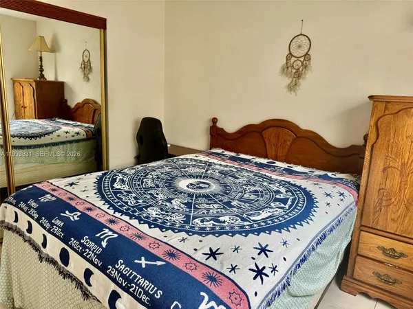 a view of a bedroom with wooden floor