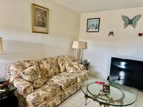 a living room with furniture and a lamp