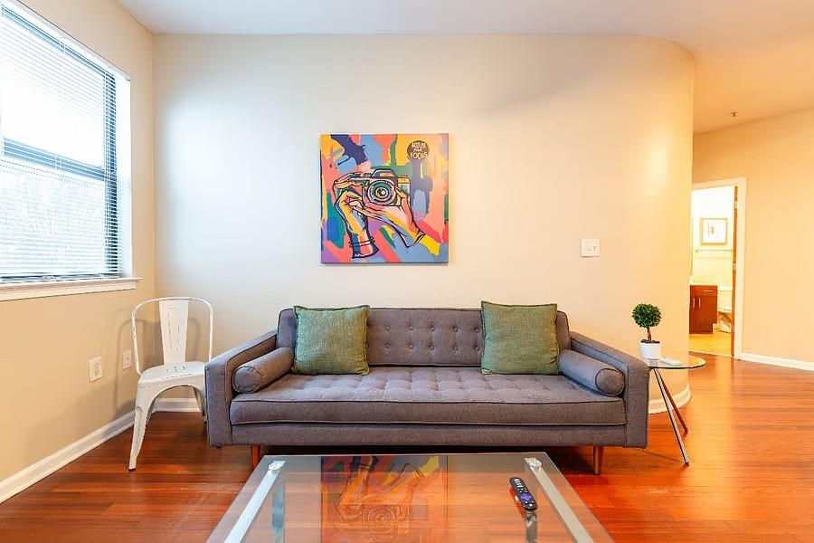 898 Oak Street Southwest Atlanta, GA 30310 - Photo 11 of 24 a bedroom with a bed and wooden floor