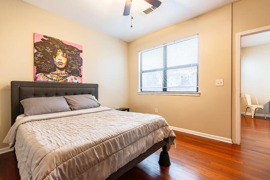 898 Oak Street Southwest Atlanta, GA 30310 - Photo 13 of 24 a bedroom with a bed and wooden floor