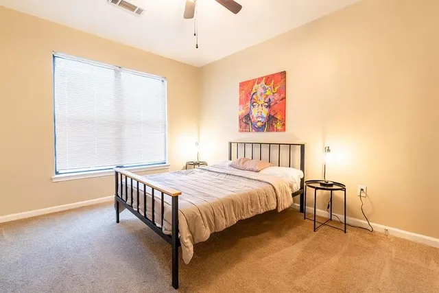 a bedroom with a bed and a window