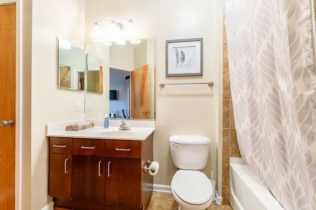a bathroom with a toilet sink and mirror