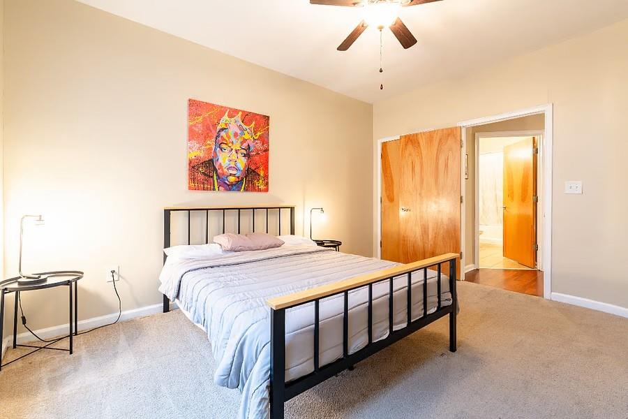 898 Oak Street Southwest Atlanta, GA 30310 - Photo 19 of 24 a bedroom with a bed table and chair