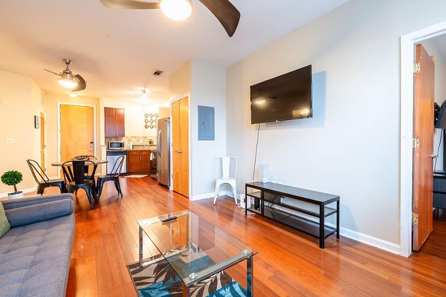 898 Oak Street Southwest Atlanta, GA 30310 - Photo 8 of 24 a living room with furniture a flat screen tv and kitchen view