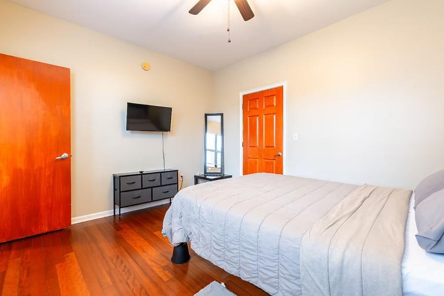 898 Oak Street Southwest Atlanta, GA 30310 - Photo 10 of 24 a bedroom with a bed and a flat screen tv