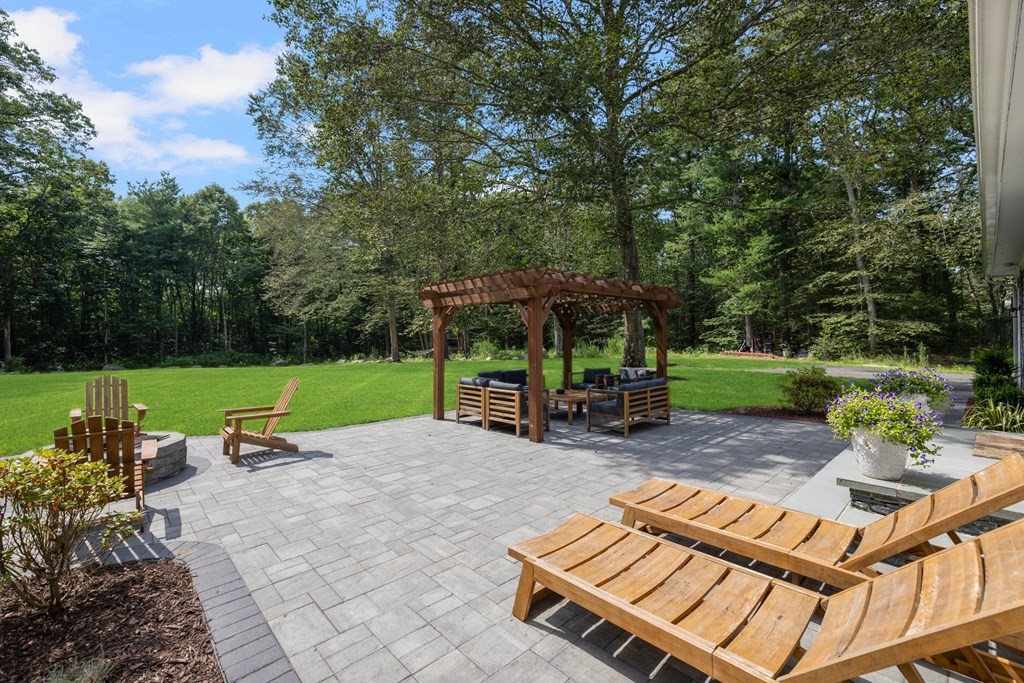 164 Rocky Hill Road Rehoboth, MA 02769 - Photo 11 of 42 a view of backyard with table and chairs and a fire pit