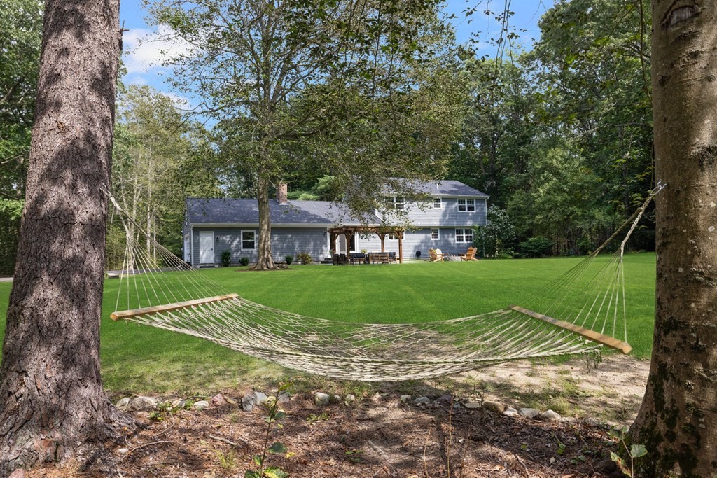 164 Rocky Hill Road Rehoboth, MA 02769 - Photo 12 of 42 a view of house in front of a big yard with large trees