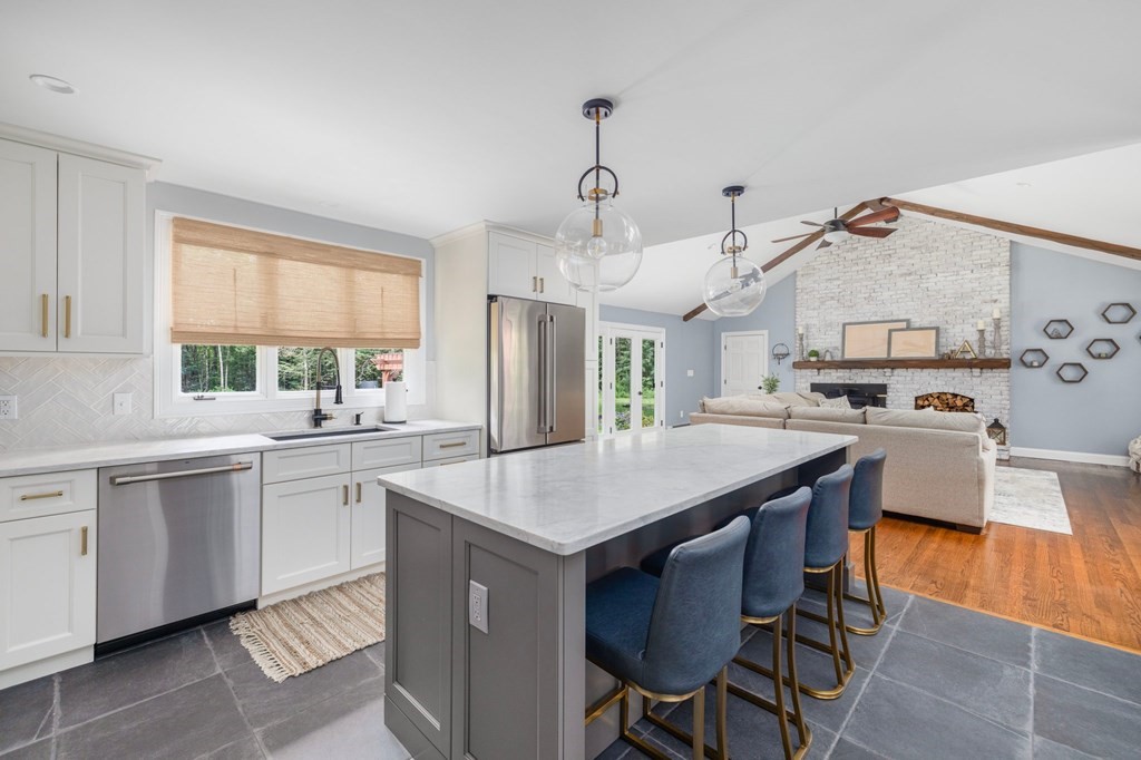 164 Rocky Hill Road Rehoboth, MA 02769 - Photo 22 of 42 a kitchen with a stove a sink a dining table and chairs