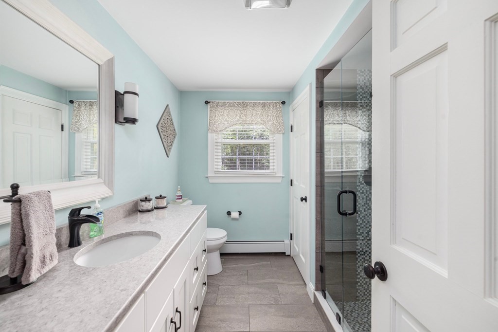 164 Rocky Hill Road Rehoboth, MA 02769 - Photo 27 of 42 a bathroom with a granite countertop tub sink and mirror