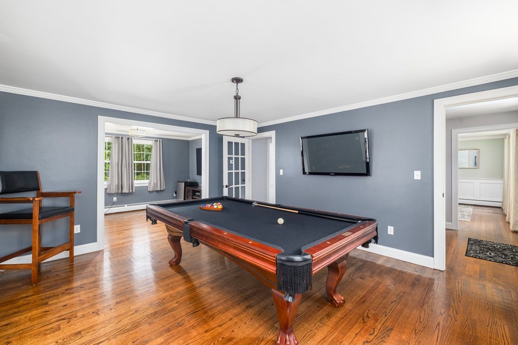 164 Rocky Hill Road Rehoboth, MA 02769 - Photo 28 of 42 a living room with pool table flat screen tv and wooden floor