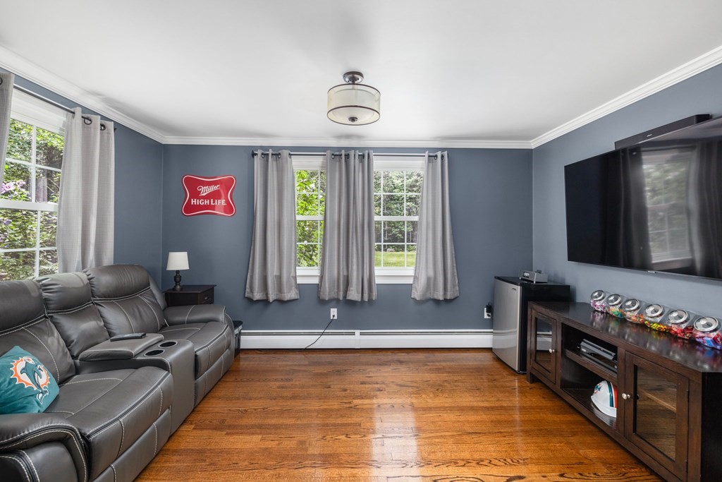 164 Rocky Hill Road Rehoboth, MA 02769 - Photo 29 of 42 a living room with furniture a flat screen tv and a window