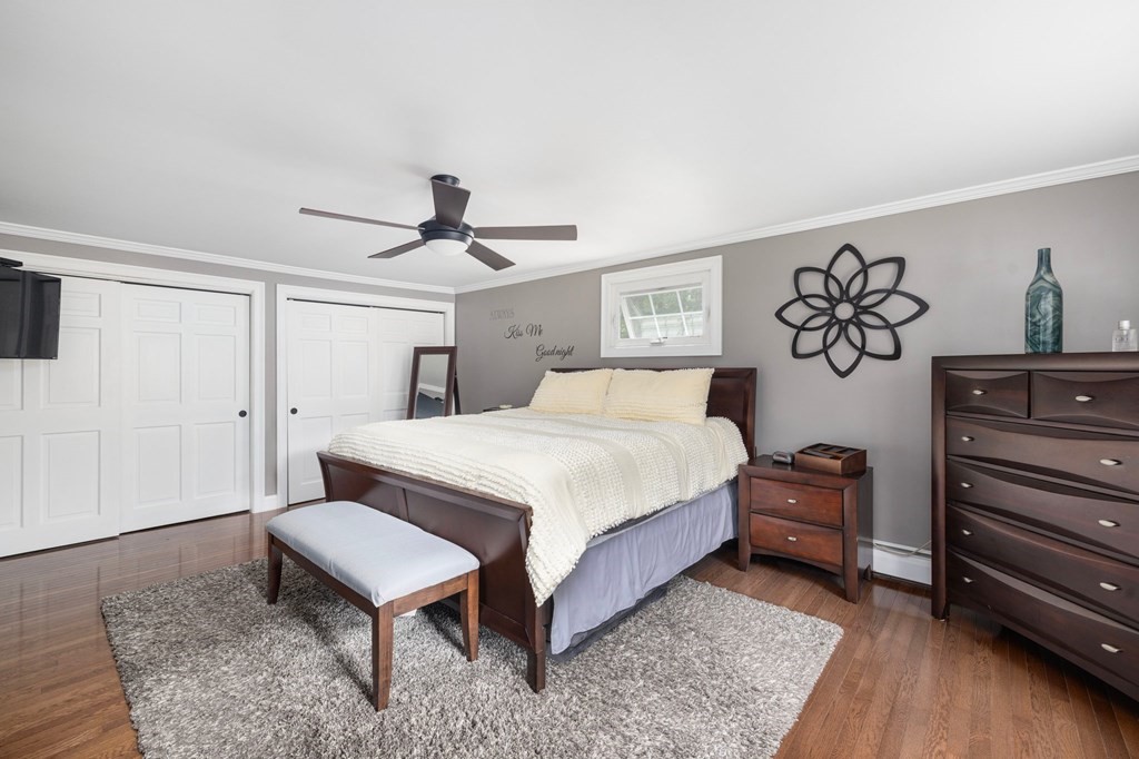 164 Rocky Hill Road Rehoboth, MA 02769 - Photo 33 of 42 a bedroom with a bed and a chandelier