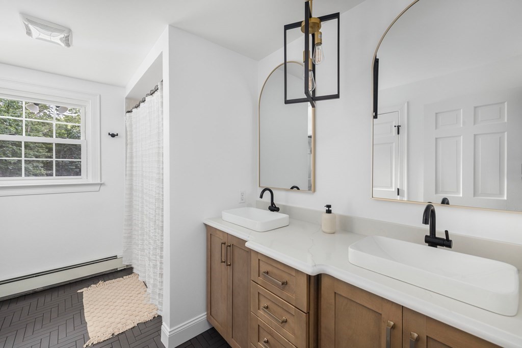 164 Rocky Hill Road Rehoboth, MA 02769 - Photo 35 of 42 a bathroom with a double vanity sink and mirror