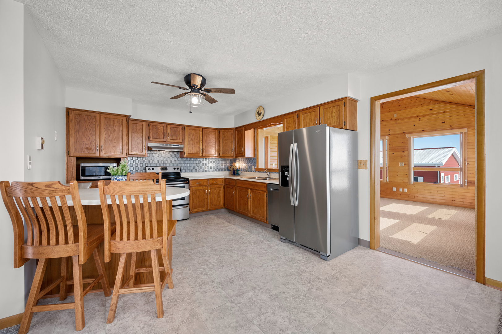 10986 Waterman Road Waterman, IL 60556 - Photo 15 of 34 a kitchen with stainless steel appliances granite countertop a refrigerator a sink a stove a dining table and chairs