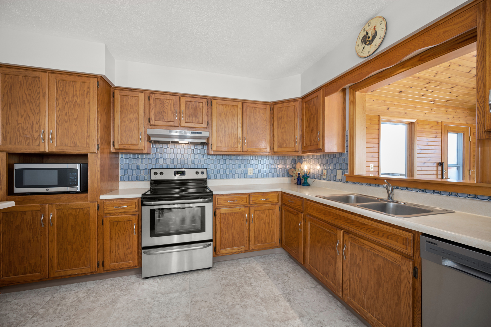 10986 Waterman Road Waterman, IL 60556 - Photo 16 of 34 a kitchen with stainless steel appliances granite countertop a sink a stove and a refrigerator