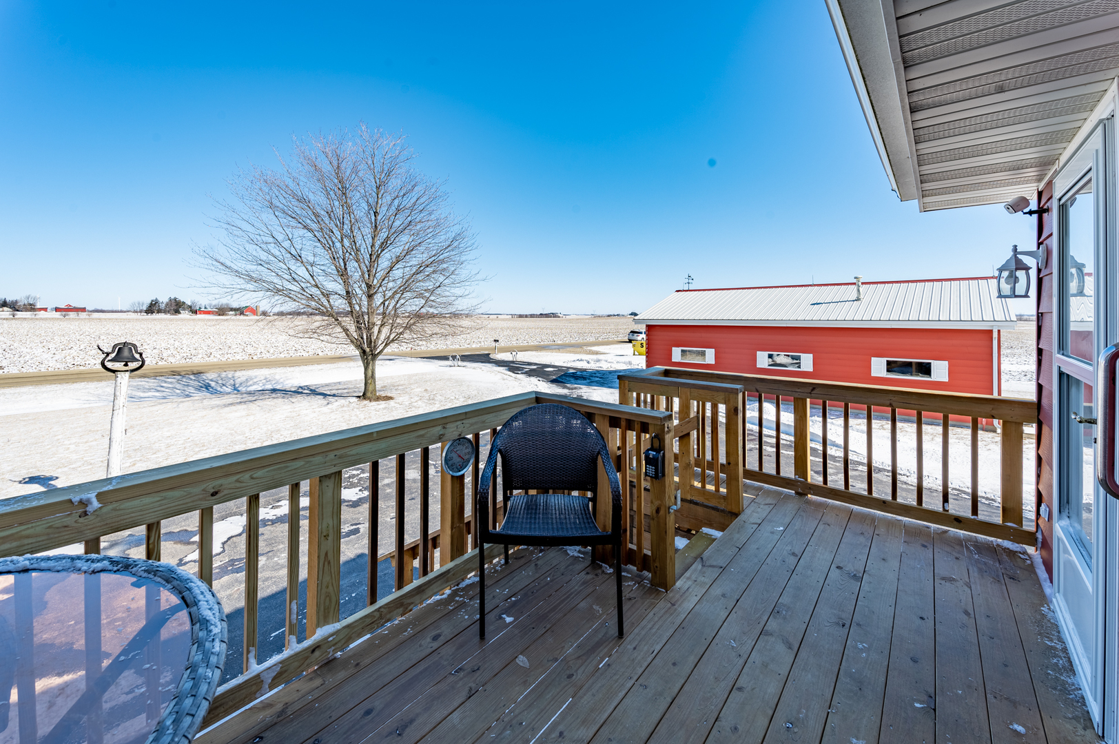 10986 Waterman Road Waterman, IL 60556 - Photo 8 of 34 a view of a balcony with furniture and wooden floor