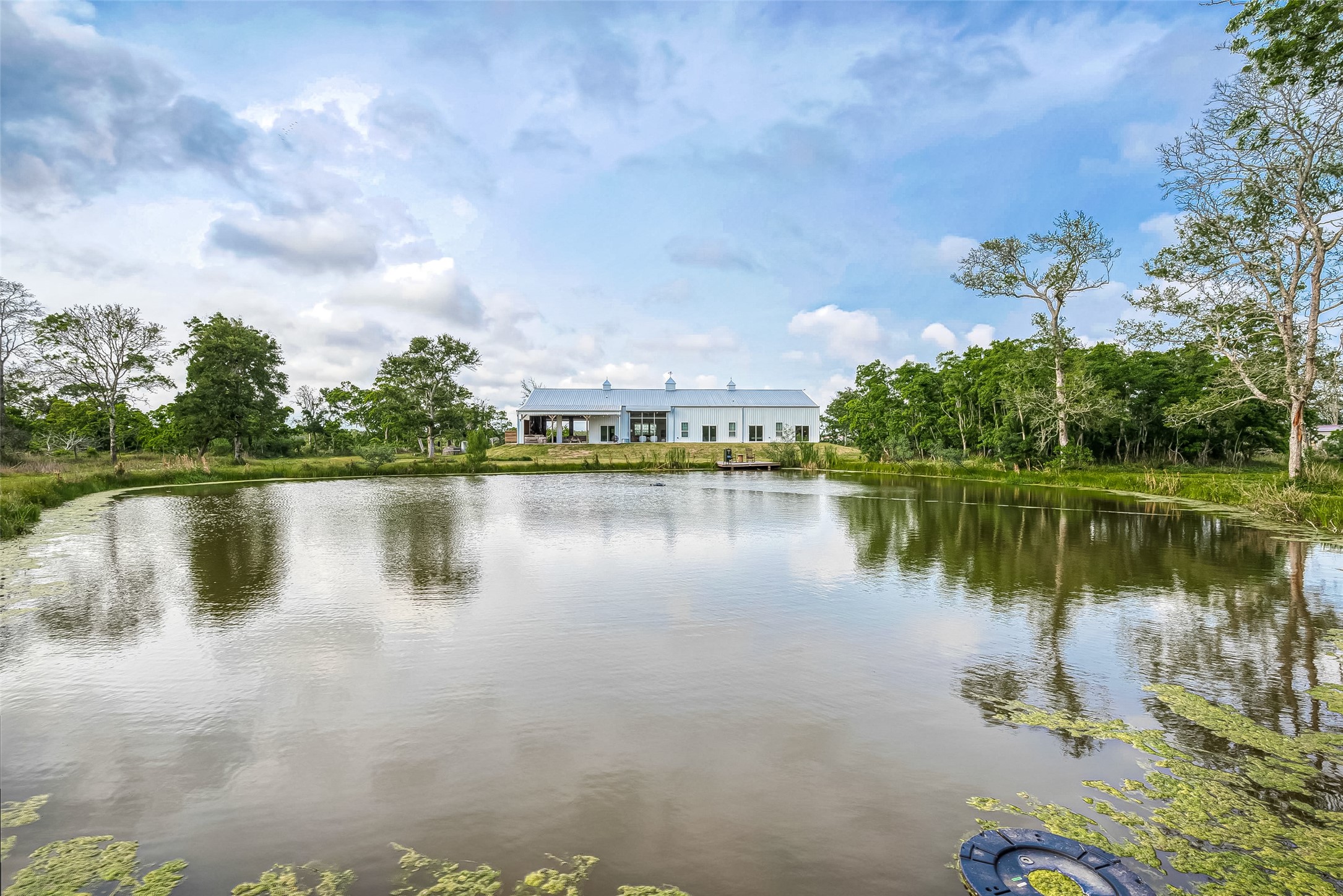 1295 Brazos River Road Freeport, TX 77541 - Photo 28 of 29 a view of a lake with a big yard and large trees